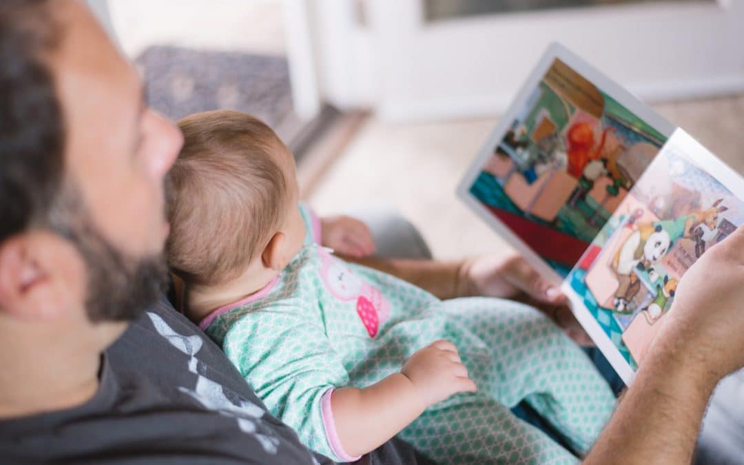 show dads reading to his newborn baby