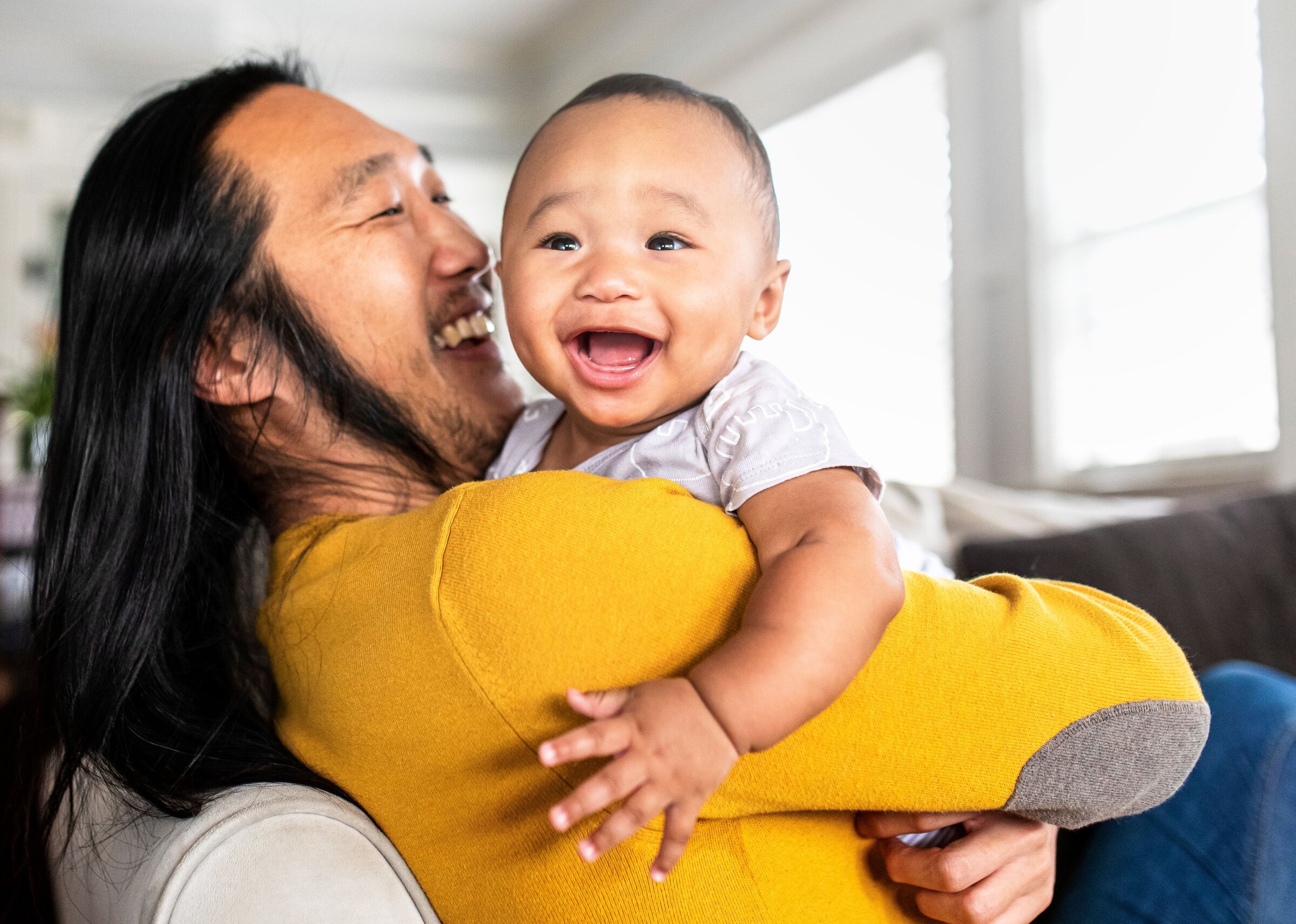 Dad-in-yellow-holding-newborn