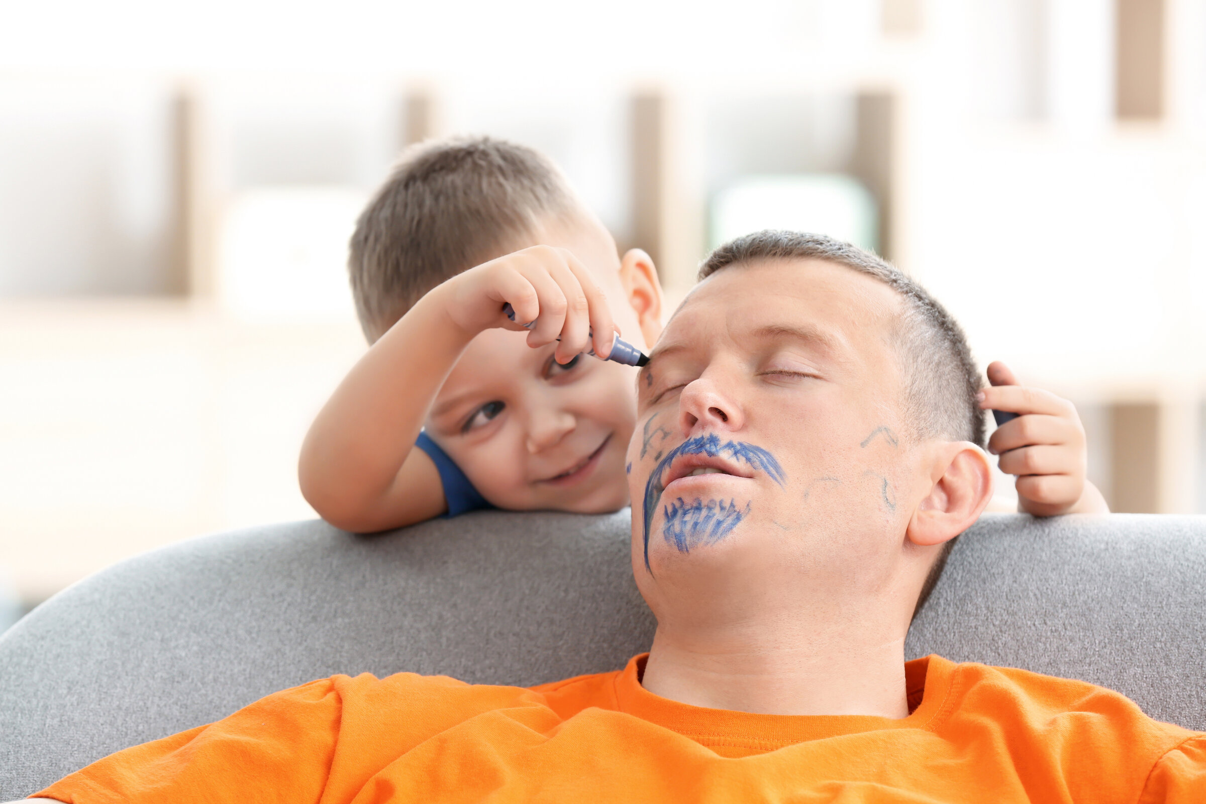 Exhausted-dad-being-coloured-on-by-toddler