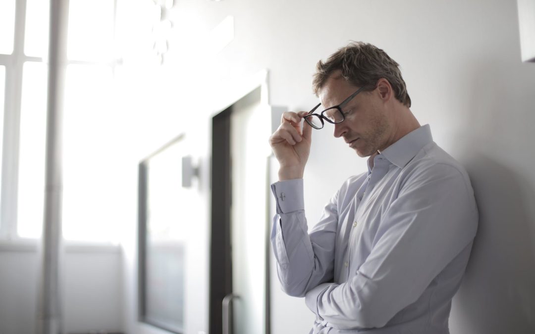 photo of man holding black eyeglasses