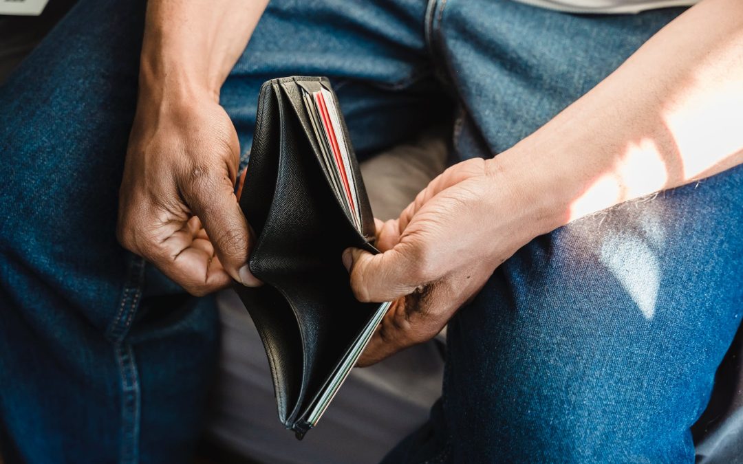 man looking at an empty wallet